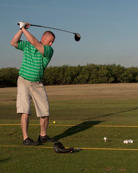 U.S. Air Force Master Sgt. Joseph Anderson, 7th Maintenance Group first sergeant, warms up at the driving line Sept. 5, 2014, at Dyess Air Force Base, Texas. Anderson participated in the Salute to Your Service golf tournament with proceeds going to local wounded combat veteran, Michael Burns, who was injured by an improvised explosive device in Iraq and medically retired in 2011. (U.S. Air Force photo by Airman 1st Class Alexander Guerrero/Released)