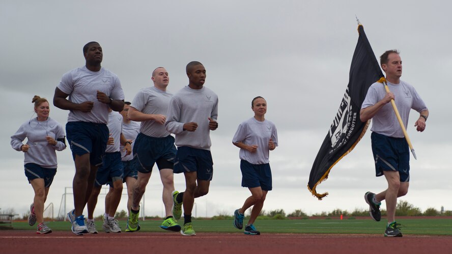 Colonel Robert Kiebler, 49th Wing commander, leads members of the Wing Staff Agencies for their running shift during Prisoner of War, Missing in Action Day of Remembrance at Holloman Air Force Base, N.M., Sept. 18.  Members of Team Holloman paid their respects during the Day of Remembrance by taking shifts with the POW/MIA flag, running a total of 24 hours, and standing a 24-hour guard at the POW/MIA memorial in Heritage Park. “We need to always remember the sacrifices of those that have gone before us,” said Kiebler. “We will never forget, and we will never rest until all of those accounted for are returned home.” (U.S. Air Force photo by Senior Airman Leah Ferrante/Released)