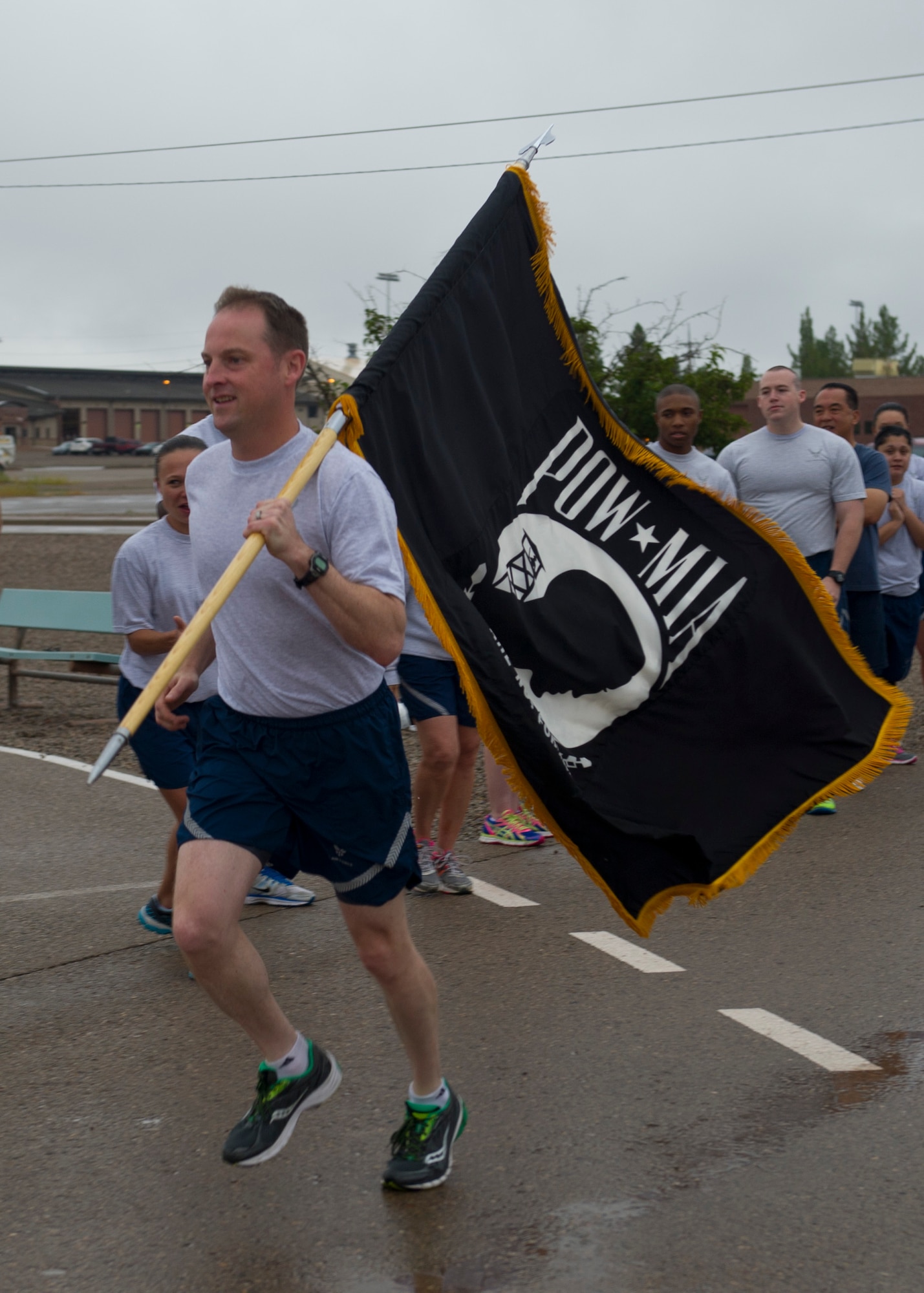 Colonel Robert Kiebler, 49th Wing commander, carries the flag starting the Prisoner of War, Missing in Action Day of Remembrance at Holloman Air Force Base, N.M., Sept. 18.  Members of Team Holloman paid their respects during the Day of Remembrance by taking shifts with the POW/MIA flag, running a total of 24 hours, and standing a 24-hour guard at the POW/MIA memorial in Heritage Park. “We need to always remember the sacrifices of those that have gone before us,” said Kiebler. “We will never forget, and we will never rest until all of those accounted for are returned home.” (U.S. Air Force photo by Senior Airman Leah Ferrante/Released)