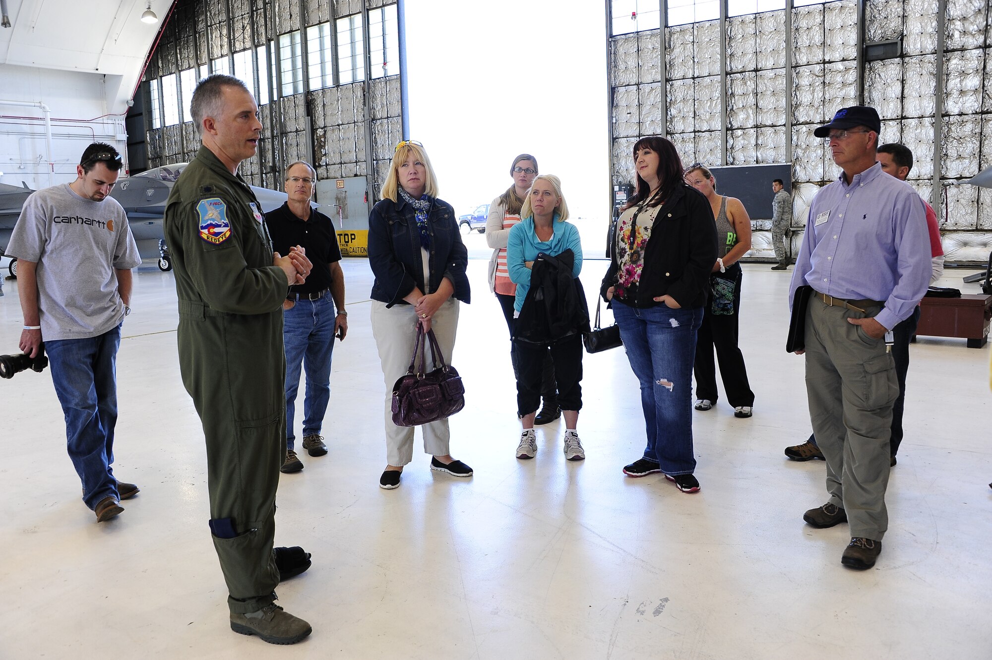 Employers of traditional Colorado National Guardsmen listen to Lt. Col. Brian Turner, a pilot with the 140th Wing, as they tour the F-16 hangar located at Buckley Air Force Base, Colo., September 13, 2014. The Colorado Employee Support of the Guard and Reserve hosted an ‘Employer’s Day’ for members of our community who were nominated by an employee and member of the Colorado National Guard.   Founded in 1972, ESGR promotes free education, consultation, and if necessary, mediation for employers of Guard and Reserve employees. Its goal is to support America’s employers who share their employees with the nation to ensure U.S. national security. (Air National Guard photo by Staff Sgt. Nicole Manzanares)