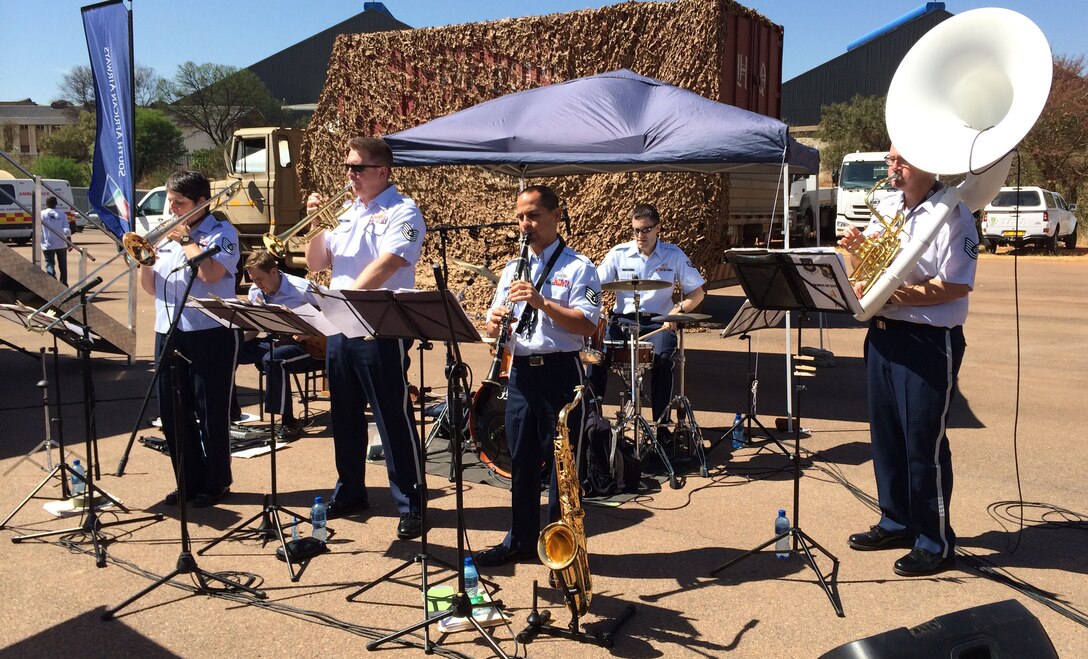 The U.S. Air Forces in Europe jazz band, Wings of Dixie, play dixieland jazz as part of the Youth Development Program at the Africa Aerospace & Defence Expo 2014 Sept. 17, 2014, at Waterkloof Air Force Base, Pretoria, South Africa. U.S. Air Force Airmen and U.S. Army Soldiers, including the Golden Knights parachute demonstration team, attended the 8th annual multinational event. United States military aircraft, including a C-130J Super Hercules and C-17 were on static display at the show. (U.S. Air Force photo by Tech. Sgt. Austin M. May/Released)