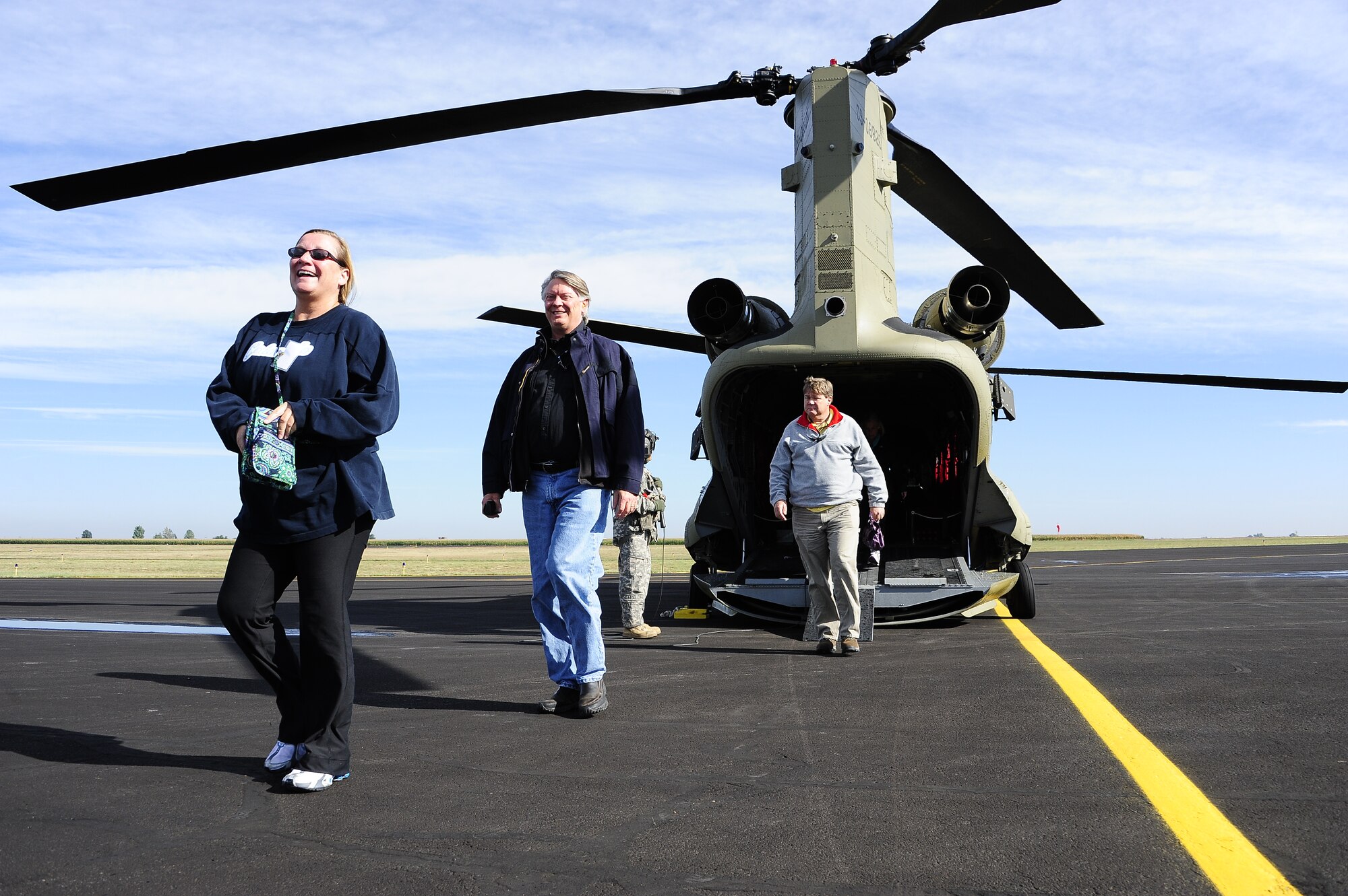 Employers of traditional Colorado National Guardsmen step off a Chinook to visit the 233rd Space Group, Greeley Air National Guard Station, Greeley, Colo., September13, 2014. The Colorado Employee Support of the Guard and Reserve hosted an ‘Employer’s Day’ for members of the community who were nominated by an employee and member of the Colorado National Guard.  Founded in 1972, ESGR promotes free education, consultation, and if necessary, mediation for employers of Guard and Reserve employees. Its goal is to support America’s employers who share their employees with the nation to ensure U.S. national security. (Air National Guard photo by Staff Sgt. Nicole Manzanares)