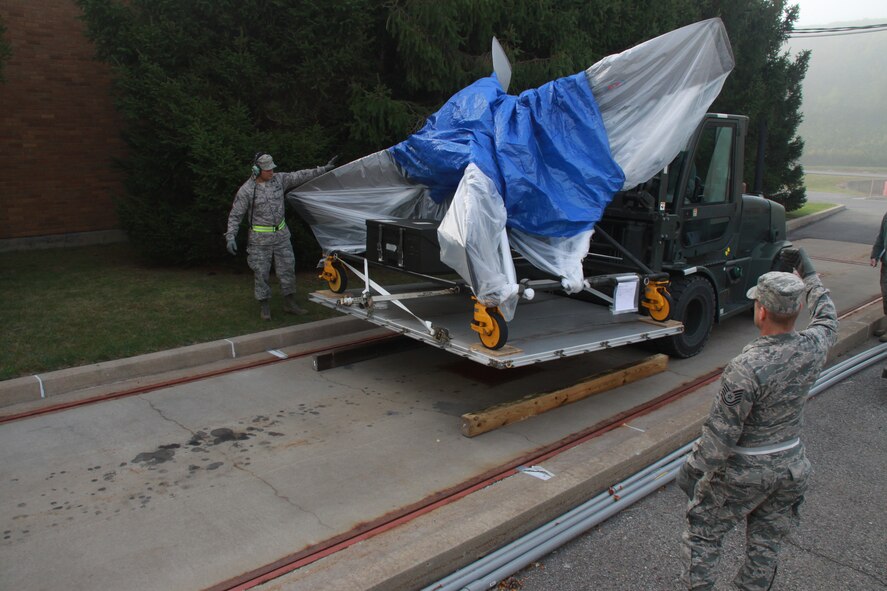 Airmen from the 32nd Aerial Port Squadron guide a forklift with a load of  cargo to a weigh station at the Pittsburgh International Airport Air Reserve Station, Sept. 14th, 2014. Weighing cargo that is part of a deployment is another key component of a mobility exercise to ensure the safety of deploying Airmen  while en route to locations around the globe. (U.S. Air Force photo by Senior Airman Justyne M. Obeldobel)