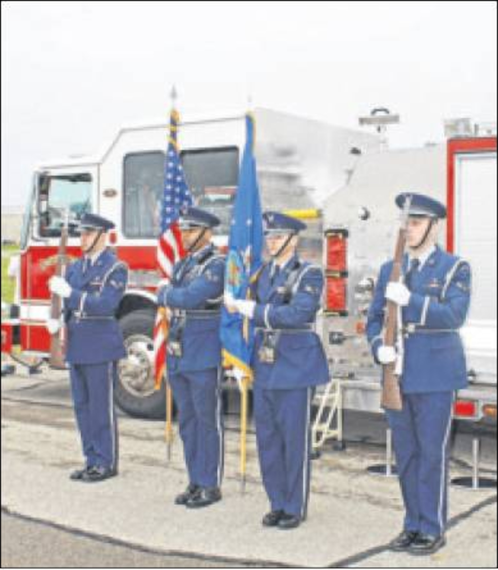 Members of the Wright-Patterson Air Force Base Honor Guard stand before a base fire truck, which included a memorial to first responders who died on Sept. 11, 2001. (Skywrighter photo by Tara Dixon Engel) 