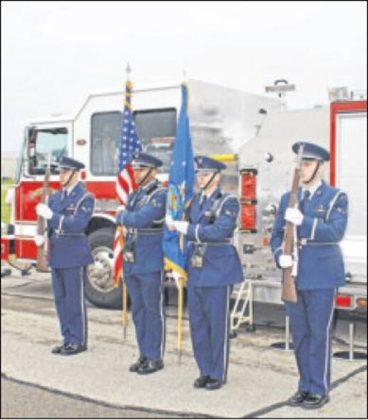 Members of the Wright-Patterson Air Force Base Honor Guard stand before a base fire truck, which included a memorial to first responders who died on Sept. 11, 2001. (Skywrighter photo by Tara Dixon Engel) 