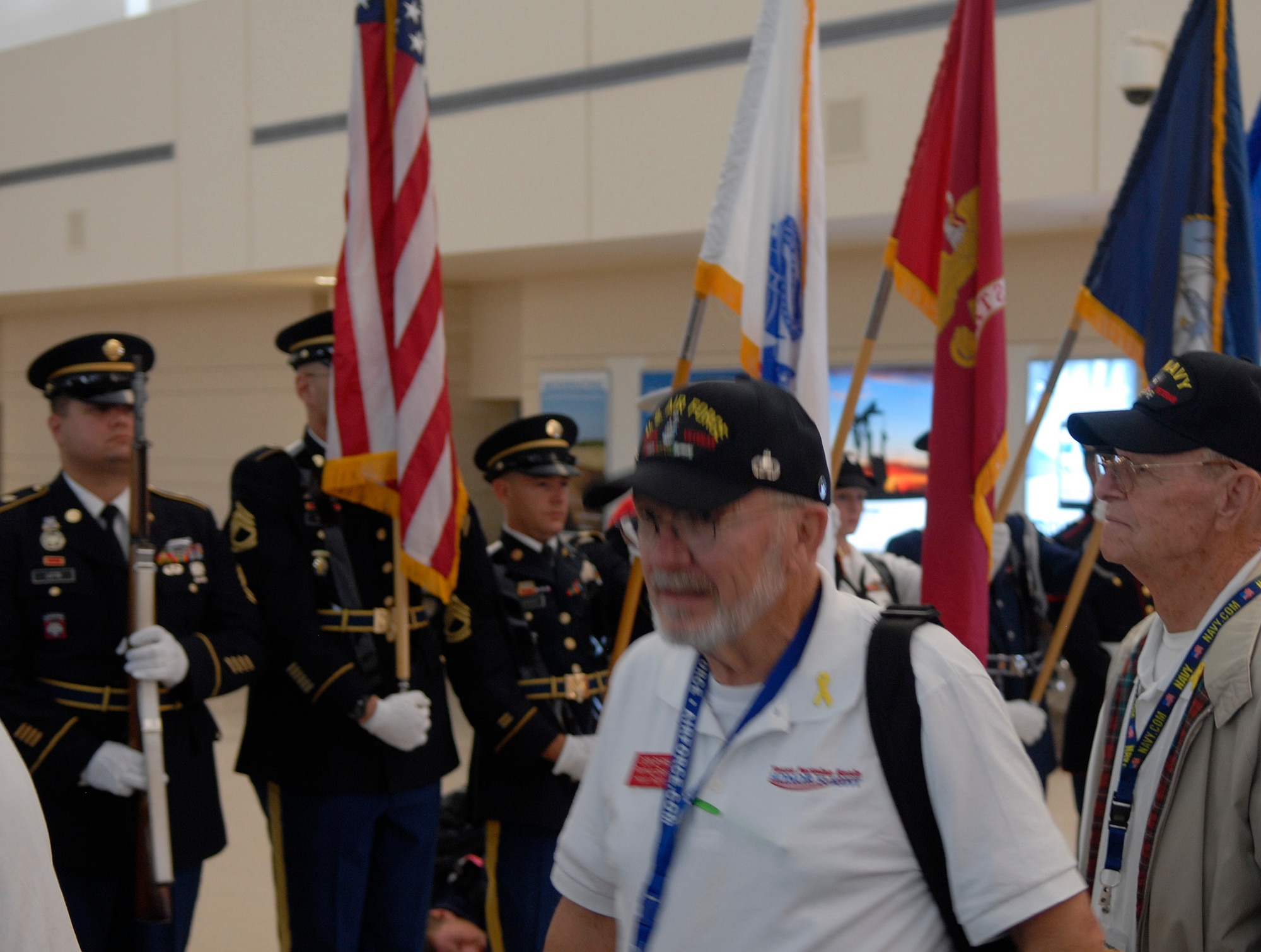 MIDLAND, Texas – Retired Air Force Lt. Col. Don Byrne boards the plane in front of the Goodfellow Joint Service Color Guard Sept. 17 at the Midland International Airport. The Color Guard presented the colors at a 6 a.m. sendoff for veterans visiting Washington, D.C. organized by the Texas Permian Basin Honor Flight. (U.S. Air Force photo/ 1st Lt. Nathaniel Roesler)