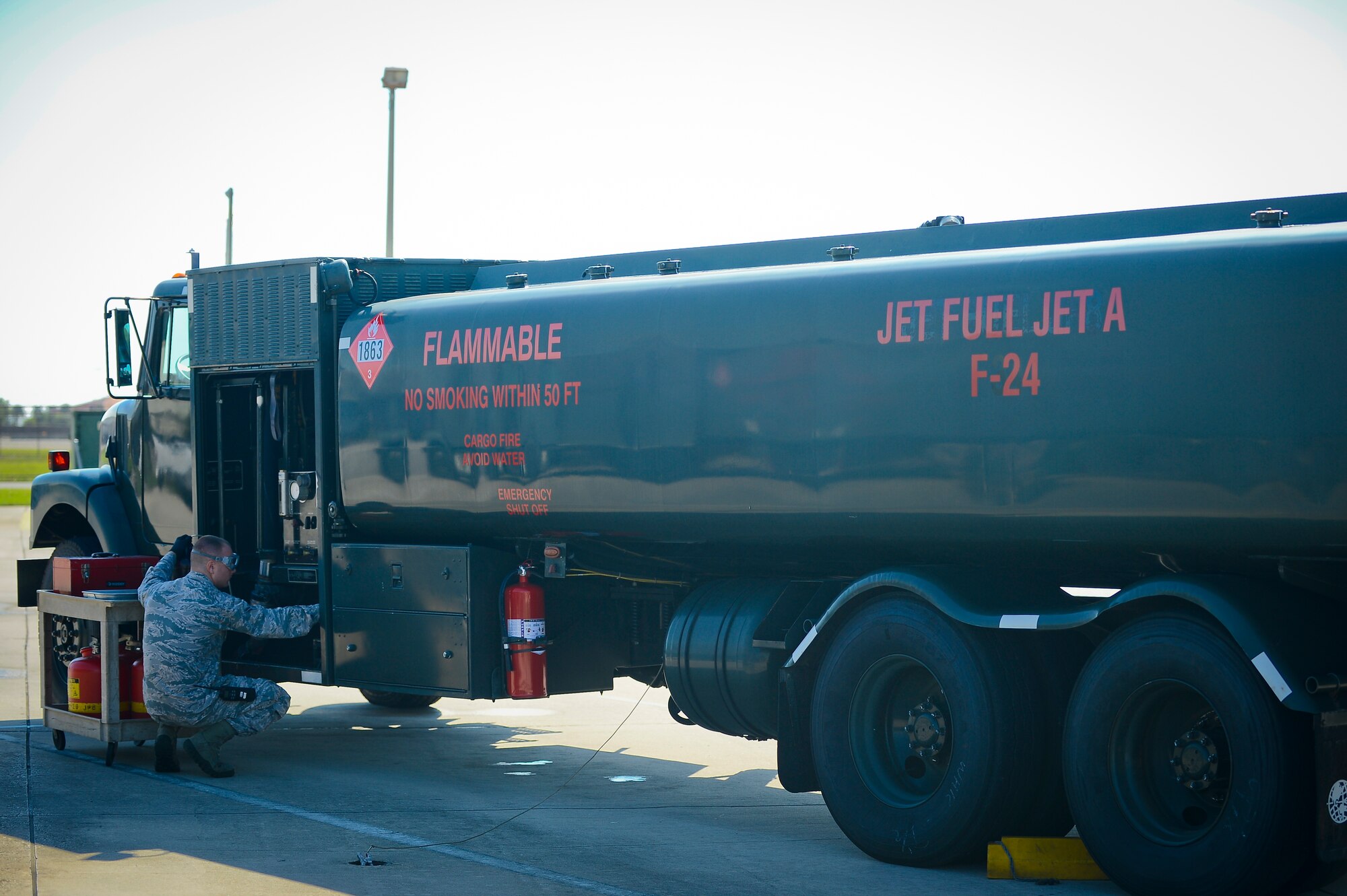 Airman 1st Class Corey Franklin, 6th Logistics Readiness Squadron fuels laboratory technician, collects a fuel sample from one of MacDill’s 14 fuel delivery trucks at MacDill Air Force Base, Fla., Sept. 18, 2014. Franklin is solely responsible for the purity of the millions of gallons of jet petroleum 8 fuel used on MacDill annually. (U.S. Air Force photo by Airman 1st Class Ned T. Johnston/Released)
