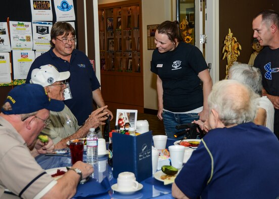 Senior Airman Kassandra VanBeek, 412th Communications Squadron cyber security technician introduces herself to resident Andy Andrews, a retired Navy pilot. (U.S. Air Force photo by Rebecca Amber)