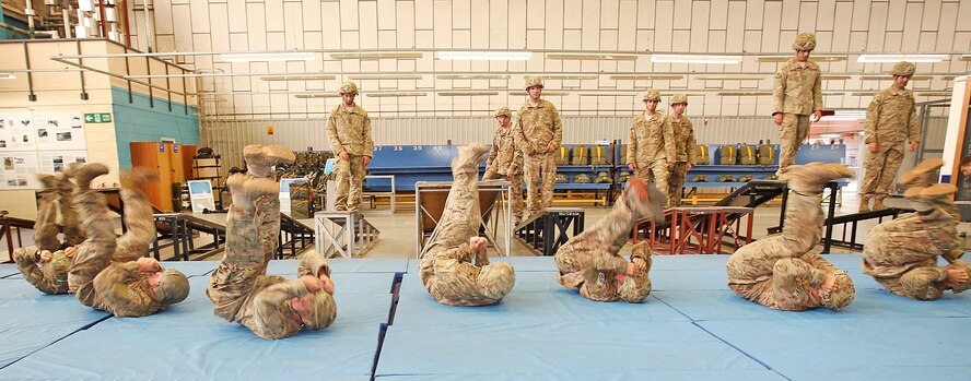 Defenders from the 823rd Base Defense Squadron execute parachute landing form during Ministry of Defense parachute training at RAF Brize Norton, England, Sept. 10. They, along with French commandos of the Commando Parachutiste De l’Air No. 20, were preparing to receive a set of British Military Parachute Wings upon completion of the final jump. (Royal Air Force courtesy photo by Cpl. Barbara Robinson/Released)