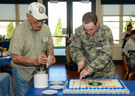 Robert Sotler, 412th Communications Squadron, wing cyber surety supervisor, was joined by retired Navy pilot Andy Andrews in cutting the Air Force birthday cake Sept.18. (U.S. Air Force photo by Rebecca Amber)