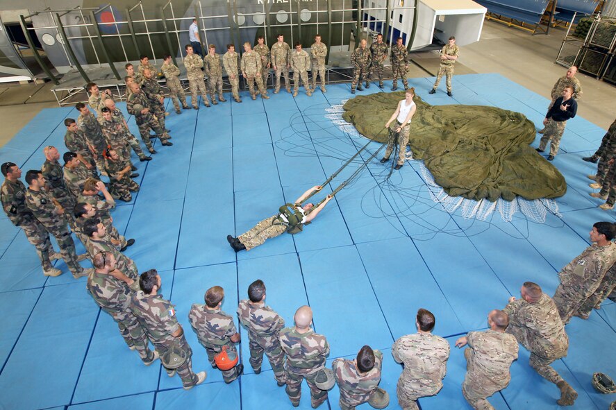 Royal Air Force personal jumping instructors teach the principles of Ministry of Defence parachute training to the force protection specialists of the 823rd Base Defense Squadron, II Squadron and Commando Parachutiste De l’Air No. 20 at RAF Brize Norton, England, Sept. 10. The jump training was the last Exercise Global Eagle activity before a culminating airborne jump out of a RAF C-130J Hercules. (Royal Air Force courtesy photo by Cpl. Barbara Robinson/Released)