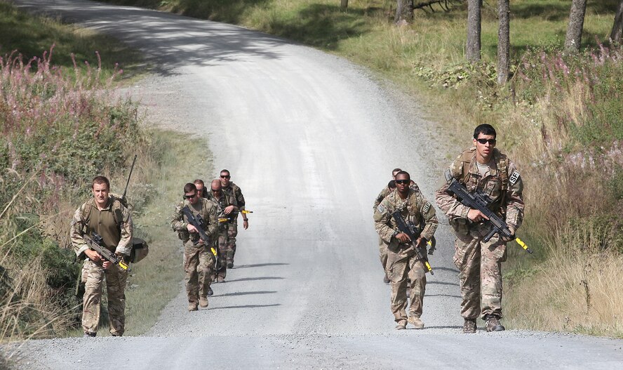 Force protection specialists from the 820th Base Defense Group, Royal Air Force Regiment and French Commando Parachutiste De l’Air begin a 15-hour land navigation course at Sennybridge Training Area, Wales, Sept. 8. The land navigation course encouraged an open exchange of tactics, techniques and procedures among the participants of Exercise Global Eagle. (Royal Air Force courtesy photo by Cpl. Barbara Robinson/Released)