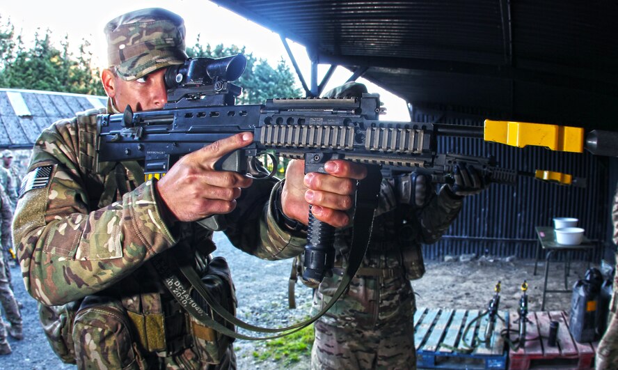 Two 823rd Base Defense Squadron defenders shoot L85 A2 British assault rifles Sept. 8 at Sennybridge Training Area, Wales. During this phase of Exercise Global Eagle, force protection specialists from the 820th Base Defense Group, RAF Regiment and Parachutiste De l’Air expanded their weapons knowledge by developing proficiencies in each other’s weapons systems. (Royal Air Force courtesy photo by Cpl. Barbara Robinson/Released)
