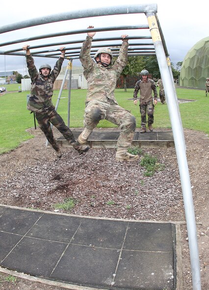 Senior Airman Romanhero Timbang, 823rd Base Defense Squadron defender, works his way through an obstacle course at Stanford Training Area, England, Sept. 1 at the start of Exercise Global Eagle. The tri-nation exercise focused on tactics, techniques and procedures exchange among American, British and French force protection units. (Royal Air Force courtesy photo by Cpl. Barbara Robinson/Released)