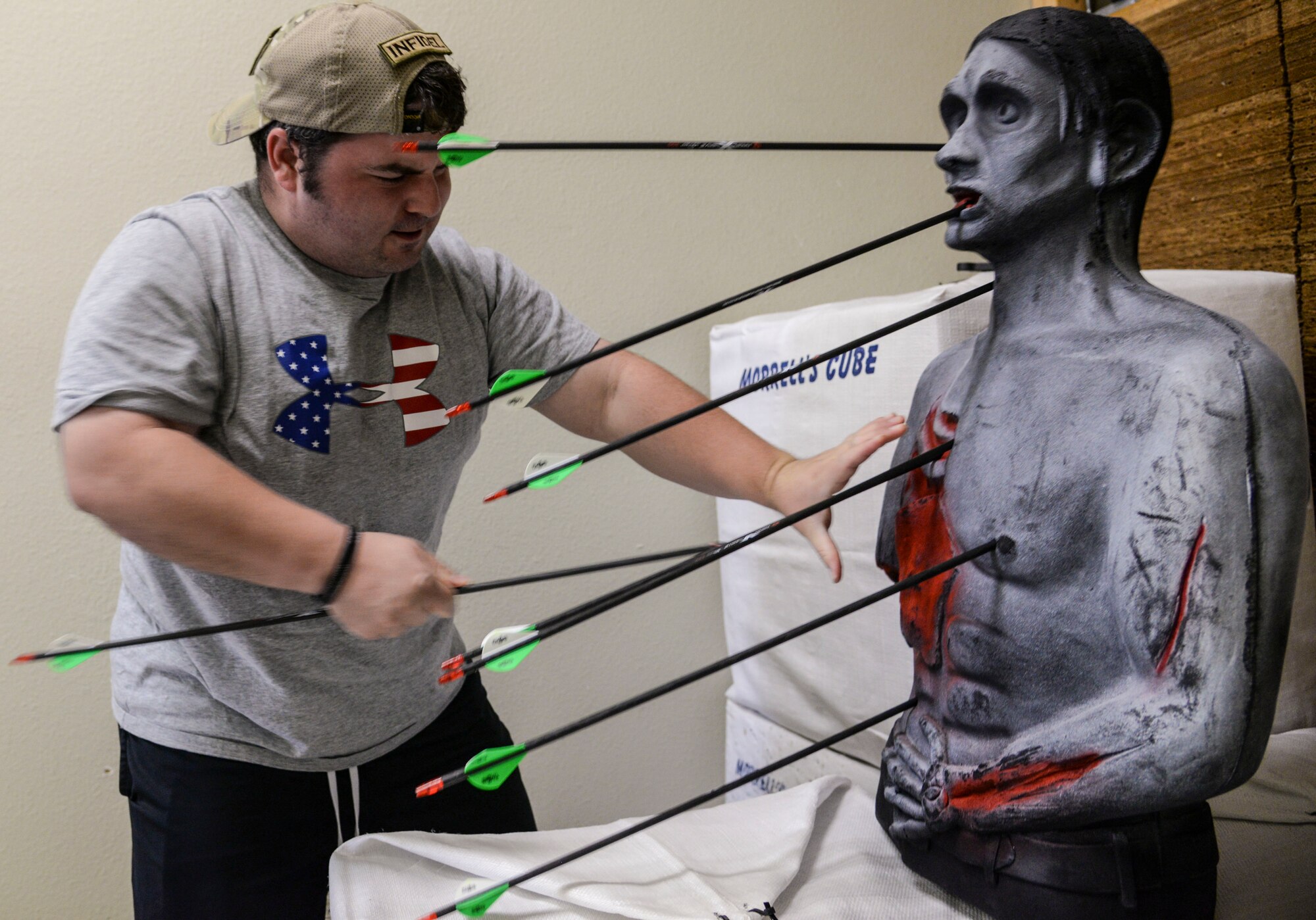 U.S. Air Force Staff Sgt. Seth Pena, a former tactical control air party member currently assigned to the 59th Medical Wing's Airman Medical Transition Unit, pulls arrows out of a dummy Sept. 12, 2014 at a local archery facility in San Antonio. After being injured by a drunk driver who ran a red light, Pena practices archery for hours each week. (U.S. Air Force photo/Senior Airman Michael Ellis)