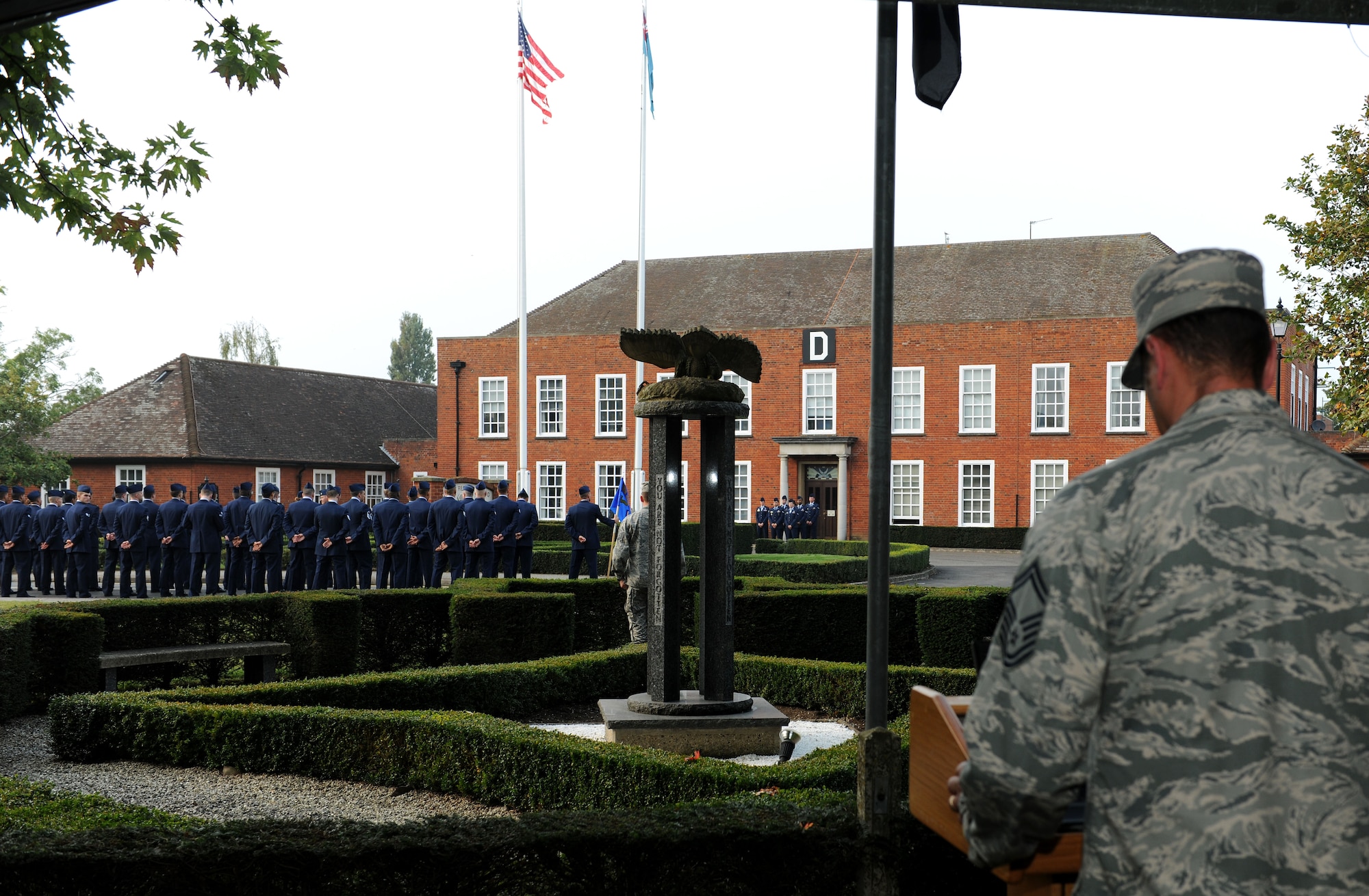 U.S. Air Force Senior Master Sgt. Ronald Garbarini, 95th Reconnaissance Squadron maintenance superintendent from Boonton, N.J., reads the names of prisoners of war/missing in action during a 24-hour vigil while Team Mildenhall members prepare for a retreat ceremony Sept. 19, 2014, on RAF Mildenhall, England. The vigil honored those service members who are lost but not forgotten. (U.S. Air Force photo/Senior Airman Kate Maurer/Released) 