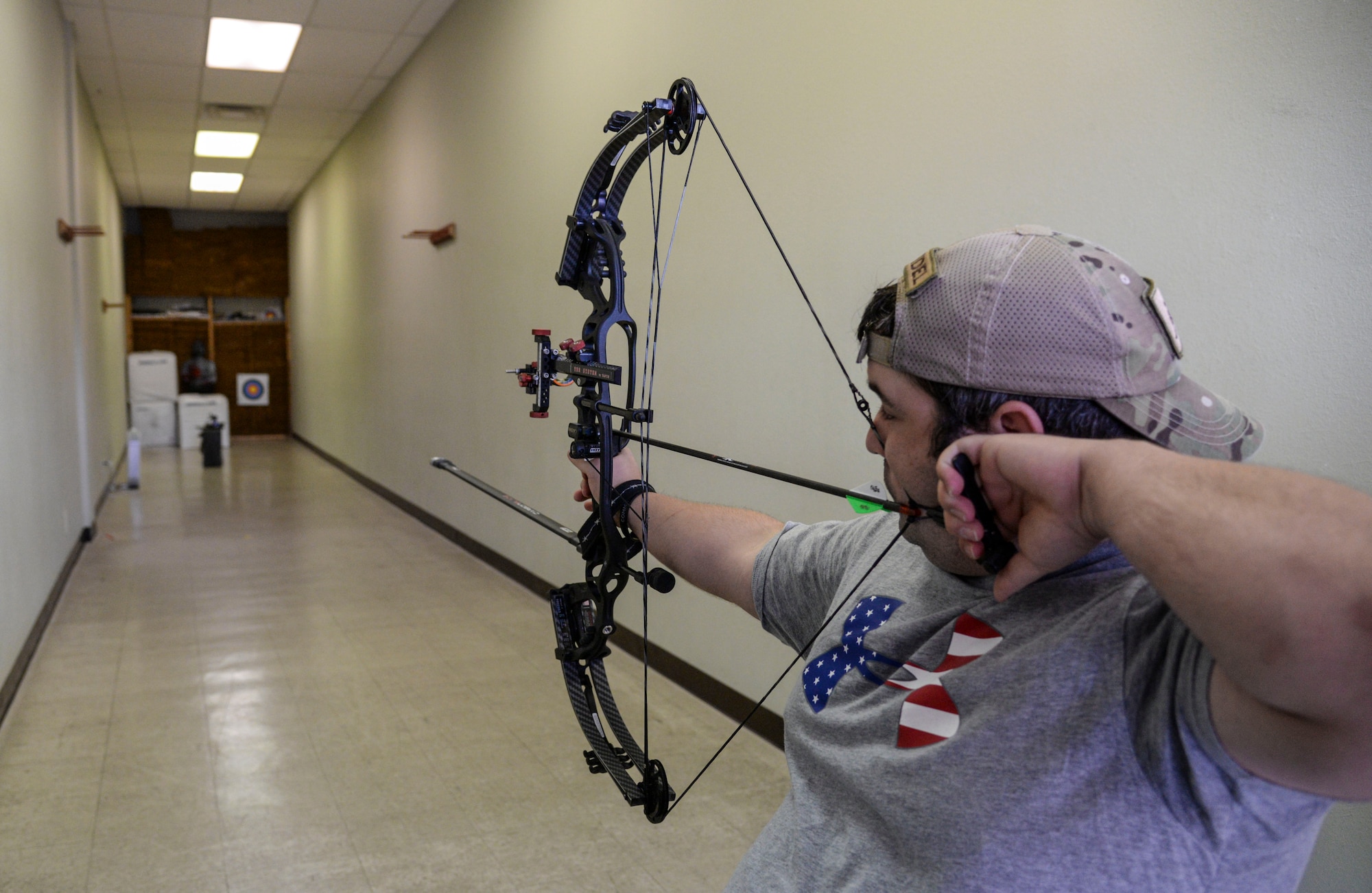 U.S. Air Force Staff Sgt. Seth Pena, a former tactical control air party member now assigned to the 59th Medical Wing's Airman Medical Transition Unit, readies his compound bow to strike a target 25 meters away Sept. 14, 2014 at a local archery facility in San Antonio. Pena is vying for a spot on the Air Force team competing at the 2014 Warrior Games Sept. 28 through Oct. 4, 2014, in Colorado Springs, Colorado. (U.S. Air Force photo/Senior Airman Michael Ellis)
