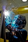 Airman 1st Class Jeremy Halcomb, 60th Maintenance Squadron Aircraft Structural Welding shop metals technologist, uses a mig welder Sept. 15 for the finishing touches on the frame of a training obstacle that will go to the 60th Security Forces Squadron Military Working Dog canines at Travis Air Force Base. The MWD unit saved nearly $30,000 by using the Airmen welders to fabricate the frame instead of purchasing from a contractor. (U.S. Air Force photo/Senior Airman Madelyn Brown)