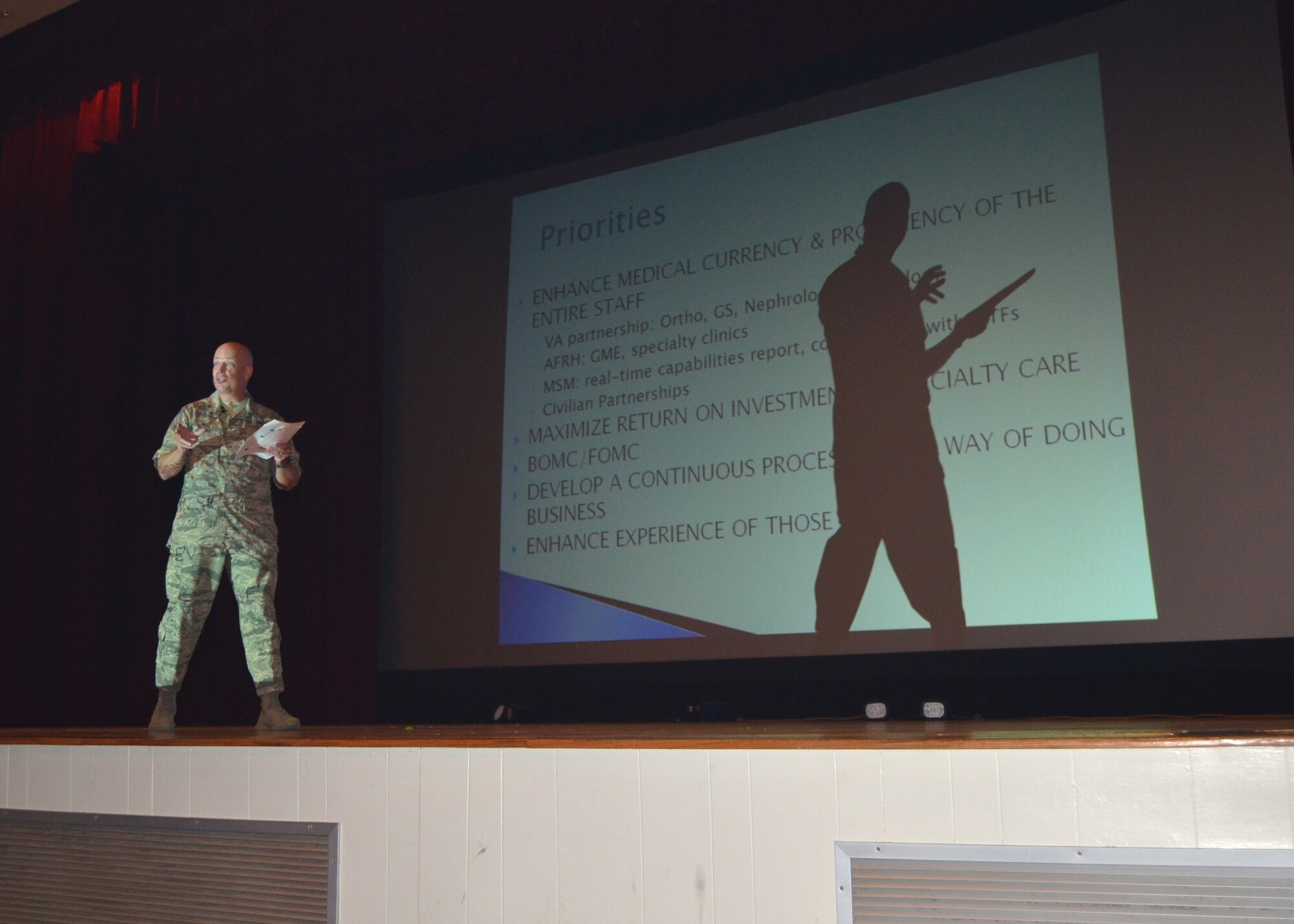 Col. (Dr.) Tom Harrell, 81st Medical Group commander, addresses “Dragon Medics” during his Sept. 4 Commander’s Call at the Welch Theater.  Utilizing smoke, music and dancers to start the session, this was not a typical commander’s call.  The colonel used the occasion to make the staff aware of the Group’s major focus areas for the next two to three years.  These include enhancing medical currency and proficiency of the entire staff; maximizing the return on investment in specialty care; Base Operational Cell and Flight Operations Medicine Clinic; developing a continuous process review way of doing business; and enhancing the experience of those the staff serves. (U.S. Air Force photo by Steve Pivnick)