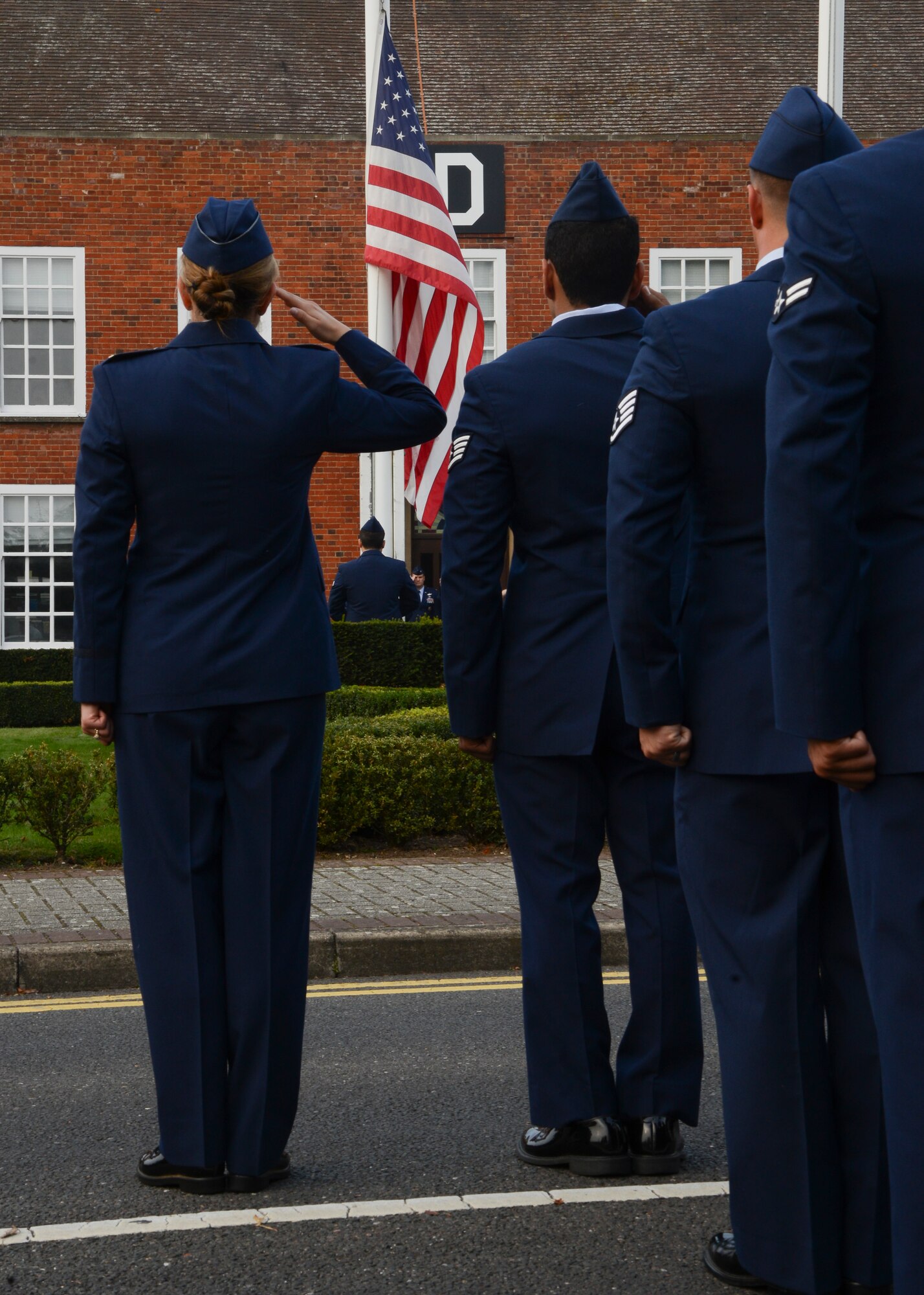 Airmen of the 352nd Special Operations Group salute the flag during a special retreat ceremony in honor of Prisoner of War/Missing in Action Remembrance week Sept. 19, 2014, on RAF Mildenhall, England. POW/MIA week is a time for the nation to pay respect to the men and women of America who sacrificed their lives in the defense of their country. (U.S. Air Force photo/Senior Airman Victoria H. Taylor/Released)