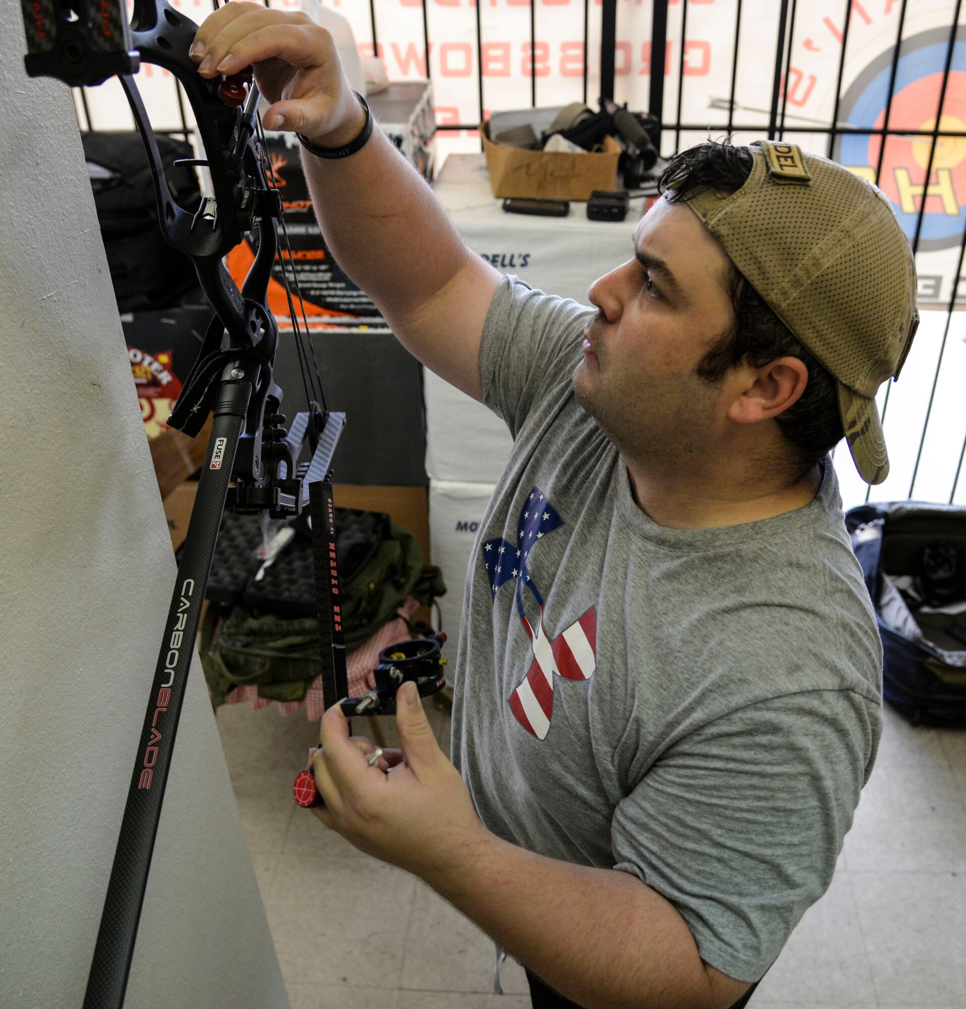 U.S. Air Force Staff Sgt. Seth Pena, a former tactical control air party member now assigned to the 59th Medical Wing's Airman Medical Transition Unit, mounts a scope to his compound bow at a local archery facility in San Antonio Sept. 12, 2014. Pena was severely injured March 2013 when a drunk driver ran a red light, crashing into his motorcycle.  (U.S. Air Force photo/Senior Airman Michael Ellis)