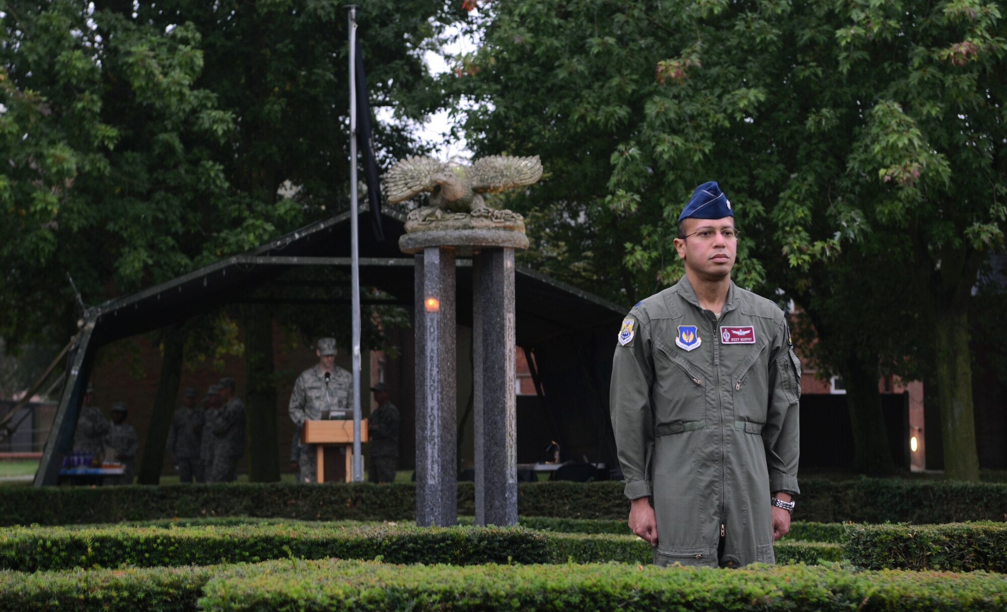 U.S. Air Force Lt. Col. Dizzy Murphy, 100th Air Refueling Wing inspector general, stands guard at the Prisoner of War/Missing in Action memorial after finishing reading names of service members who are still unaccounted for Sept. 19, 2014, at RAF Mildenhall, England. Each year, Team Mildenhall members participate in a day of remembrance through a 24-hour vigil for all POW/MIA. (U.S. Air Force photo/Airman 1st Class Dillon Johnston/Released)