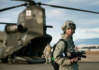 Staff Sgt. John Ayre, 60th Air Mobility Wing multimedia production section chief, prepares to film members of the 621st Contingency Response Wing, 60th Aerial Port Squadron and the California Army National Guard for joint sling-load training with a CH-47 Chinook and two Humvees Nov. 21, 2013, at Travis Air Force Base, Calif. (U.S. Air Force photo/T.C. Perkins Jr.)