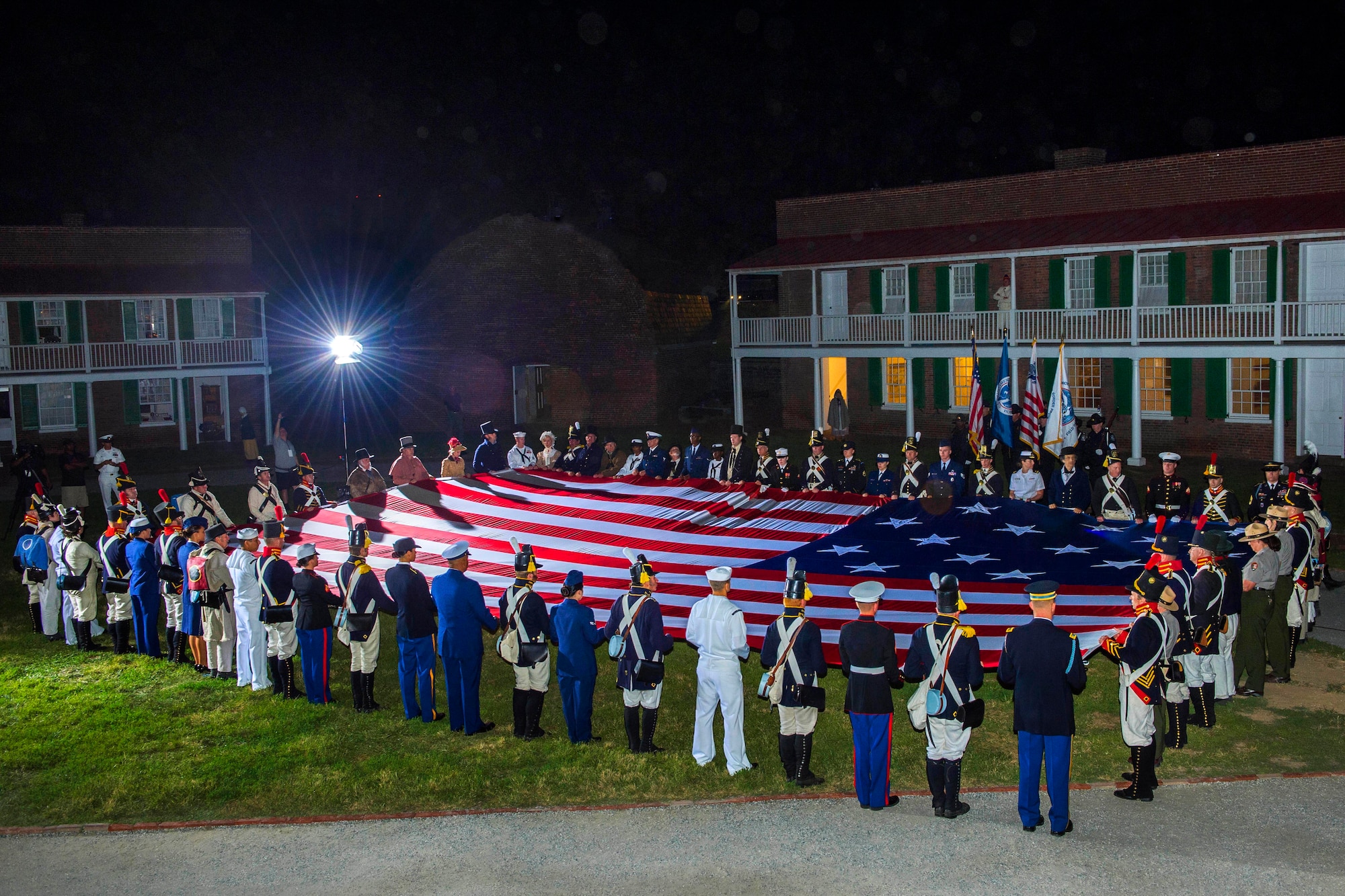 Service members, Fort McHenry staff and volunteers participate in a flag-raising ceremony rehearsal as part of the Star-Spangled Spectacular celebration in Baltimore, Sept. 12, 2014. The event celebrates the bicentennial of the Battle of Baltimore, which provided the backdrop for Francis Scott Key's famous poem, "Defense of Fort McHenry," which later became America's national anthem. (U.S. Navy photo/Petty Officer 3rd Class Laura Hoover)