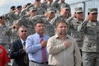 The crowd salutes during the retreat portion of the Prisoners of War and Missing in Action ceremonies at Joint Base San Antonio-Randolph Sept. 18.  Each year these ceremonies are hosted at the Missing Man Monument.  This year the event included a wreath laying, 21-gun salute, retreat and a motorcycle procession. (U.S. Air Force photo/Desiree N. Palacios)