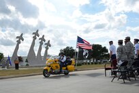 One of the Patriot Guard motorcycle riders leads a roll by to welcome those who have returned home and to honor families of those still missing.  The Prisoners of War and Missing in Action wreath laying and retreat ceremonies were held at Joint Base San Antonio-Randolph Sept. 18 at the Missing Man Monument.  (U.S. Air Force photo/Desiree N. Palacios)