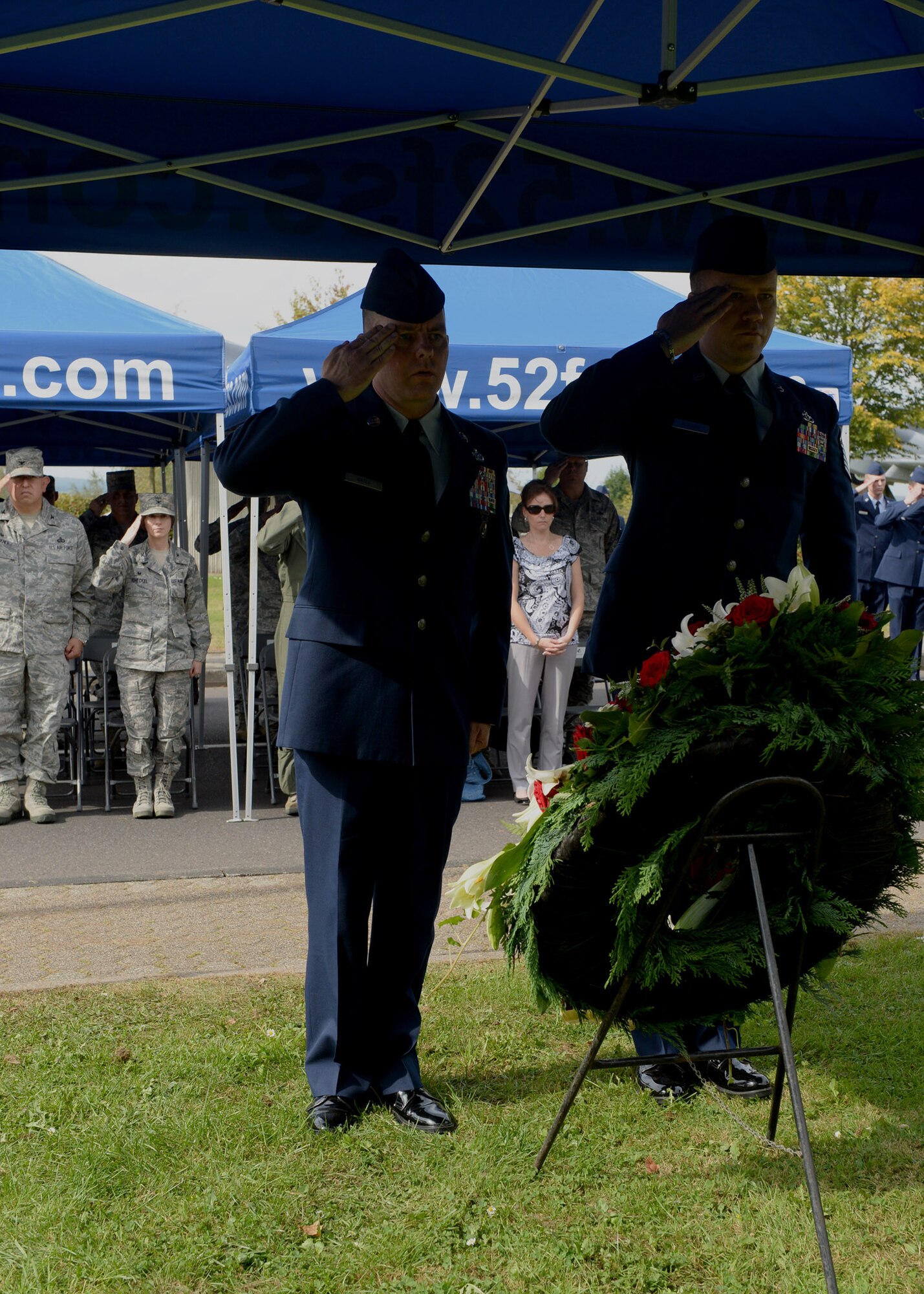 U.S. Air Force Chief Master Sgt. Brian Gates, left, and U.S. Air Force Master Sgt. Michael Murieen, 52nd Civil Engineer Squadron water and fuel systems maintenance section chief, salute the POW/MIA wreath during the ceremony at the Air Park on Spangdahlem Air Base, Germany, Sept. 19, 2014. The Honor Guard bugler played taps during the placing of the wreath in memory of those honored. (U.S. Air Force photo by Airman 1st Class Timothy Kim/Released)
