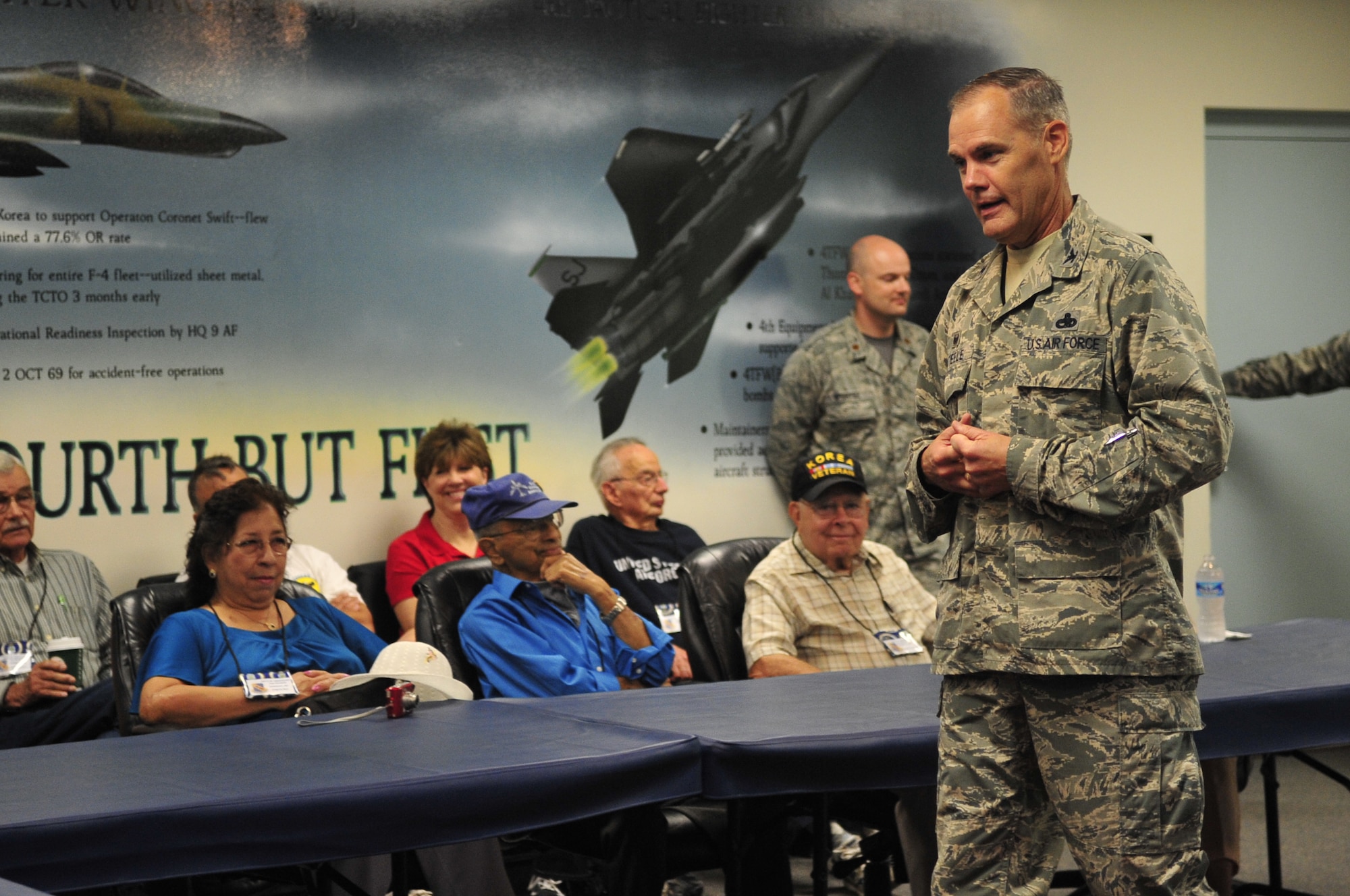 Col. Darrell Steele, 4th Maintenance Group commander, addresses a group of Korean War veterans and their families during the 4th Fighter Interceptor Wing reunion at Seymour Johnson Air Force Base, North Carolina Sept. 12. The veterans, who were assigned to the 4th FIW during the Korean War, toured much of the base and held several functions Sept. 11-13. (U.S. Air Force photo/Airman 1st Class Shawna Keyes)