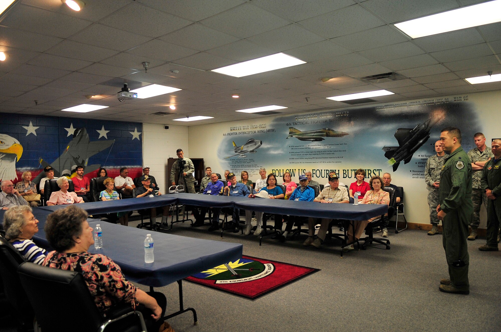 Lt. Col. Donn Yates, 334th Fighter Squadron commander, addresses a group of Korean War veterans and their families during the 4th Fighter Interceptor Wing reunion at Seymour Johnson Air Force Base, North Carolina Sept. 12. The veterans, who were assigned to the 4th FIW during the Korean War, toured much of the base and held several functions Sept. 11-13. (U.S. Air Force photo/Airman 1st Class Shawna Keyes)