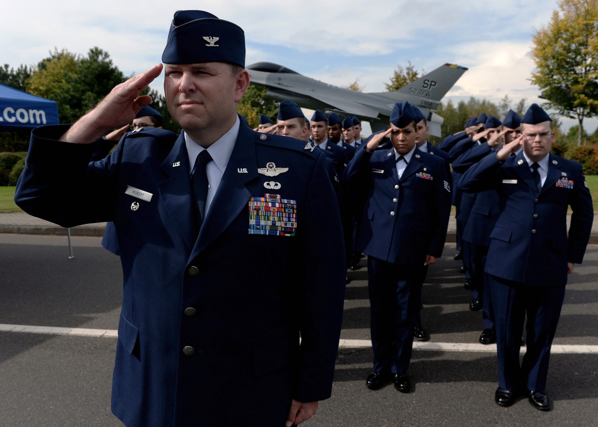U.S. Air Force Col. Lars Hubert, 52nd Fighter Wing vice commander, salutes during the presentation of the colors with his flight during the POW/MIA ceremony at the Air Park on Spangdahlem Air Base, Germany, Sept. 19, 2014. The ceremony was held in remembrance of U.S. military personnel held as prisoners of war or missing in action. (U.S. Air Force photo by Airman 1st Class Timothy Kim/Released)