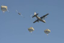 U.S., British, Dutch and Polish troops parachute from a Kentucky Air National Guard C-130 near Groesbeek, Netherlands, Sept. 18, 2014, as part of the 70th-anniversary re-enactment of Operation Market Garden. The historic World War II mission was, at the time, the largest airborne assault ever conducted. (U.S. Air National Guard photo by Master Sgt. Charles Delano)