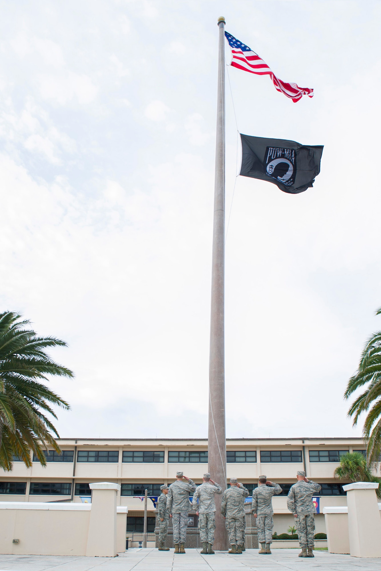Members of Team Patrick-Cape salute the American flag and the POW/MIA flag, during the POW/MIA remembrance ceremony, Sept. 19, 2014, at Patrick Air Force Base, Fla. Aside from Old Glory, the POW/MIA flag is the only flag that has flown above the White House. (U.S. Air Force photo/Matthew Jurgens/Released)