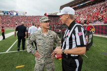 Air Force Brig. Gen. Warren Hurst, the Kentucky National Guard's assistant adjutant general for Air and commander of the Kentucky Air National Guard, speaks with head referee Jeff Heaser at Papa John’s Cardinal Stadium in Louisville, Ky., prior to the University of Louisville – Murray State football game Sept. 6, 2014. The game, billed as Military Appreciation Day, began with a coin toss executed Hurst. (U.S. Air National Guard photo by Maj. Dale Greer/Released)