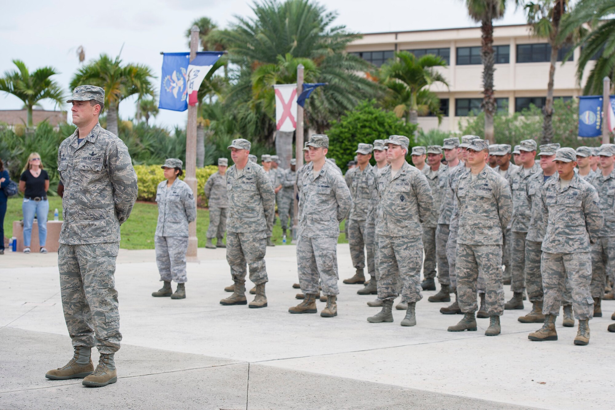 Col. Thomas Falzarano, 45th Operations Group commander, (left), and members of Team Patrick-Cape, stand at ease prior to the POW/MIA remembrance ceremony, Sept. 19, 2014 at Patrick Air Force Base, Fla. Each year, the president issues a proclamation honoring and recognizing the sacrifices of America’s POWs and MIAs, both those returned and those still missing, and their families, designating the third Friday in September as national POW/MIA recognition day. (U.S. Air Force photo/Matthew Jurgens/Released)