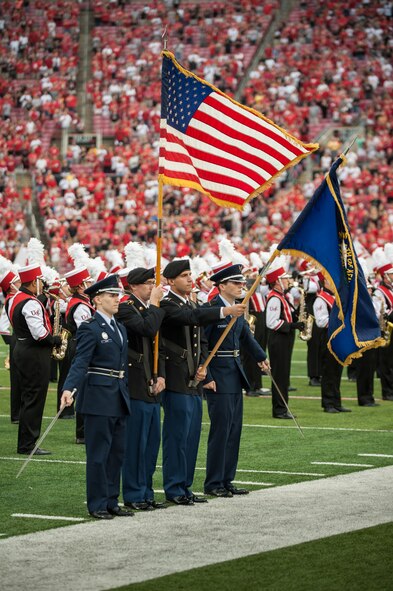 The University of Louisville honors servicemembers during the U of L-Murray State football game at Papa John's Cardinal Stadium in Louisville, Ky., Sept. 6, 2014. The game, billed as Military Appreciation Day, started with a coin toss executed by Air Force Brig. Gen. Warren Hurst, the Kentucky National Guard's assistant adjutant general for Air and commander of the Kentucky Air National Guard. Recruiters from the Kentucky Army and Air Guard also set up booths featuring displays of military equipment and answered questions posed by hundreds of fans. (U.S. Air National Guard photo by Maj. Dale Greer/Released)