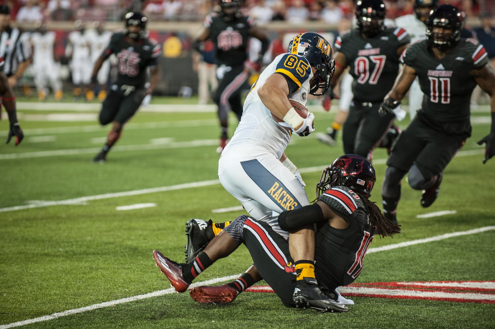 The University of Louisville honors servicemembers during the U of L-Murray State football game at Papa John's Cardinal Stadium in Louisville, Ky., Sept. 6, 2014. The game, billed as Military Appreciation Day, started with a coin toss executed by Air Force Brig. Gen. Warren Hurst, the Kentucky National Guard's assistant adjutant general for Air and commander of the Kentucky Air National Guard. Recruiters from the Kentucky Army and Air Guard also set up booths featuring displays of military equipment and answered questions posed by hundreds of fans. (U.S. Air National Guard photo by Maj. Dale Greer/Released)