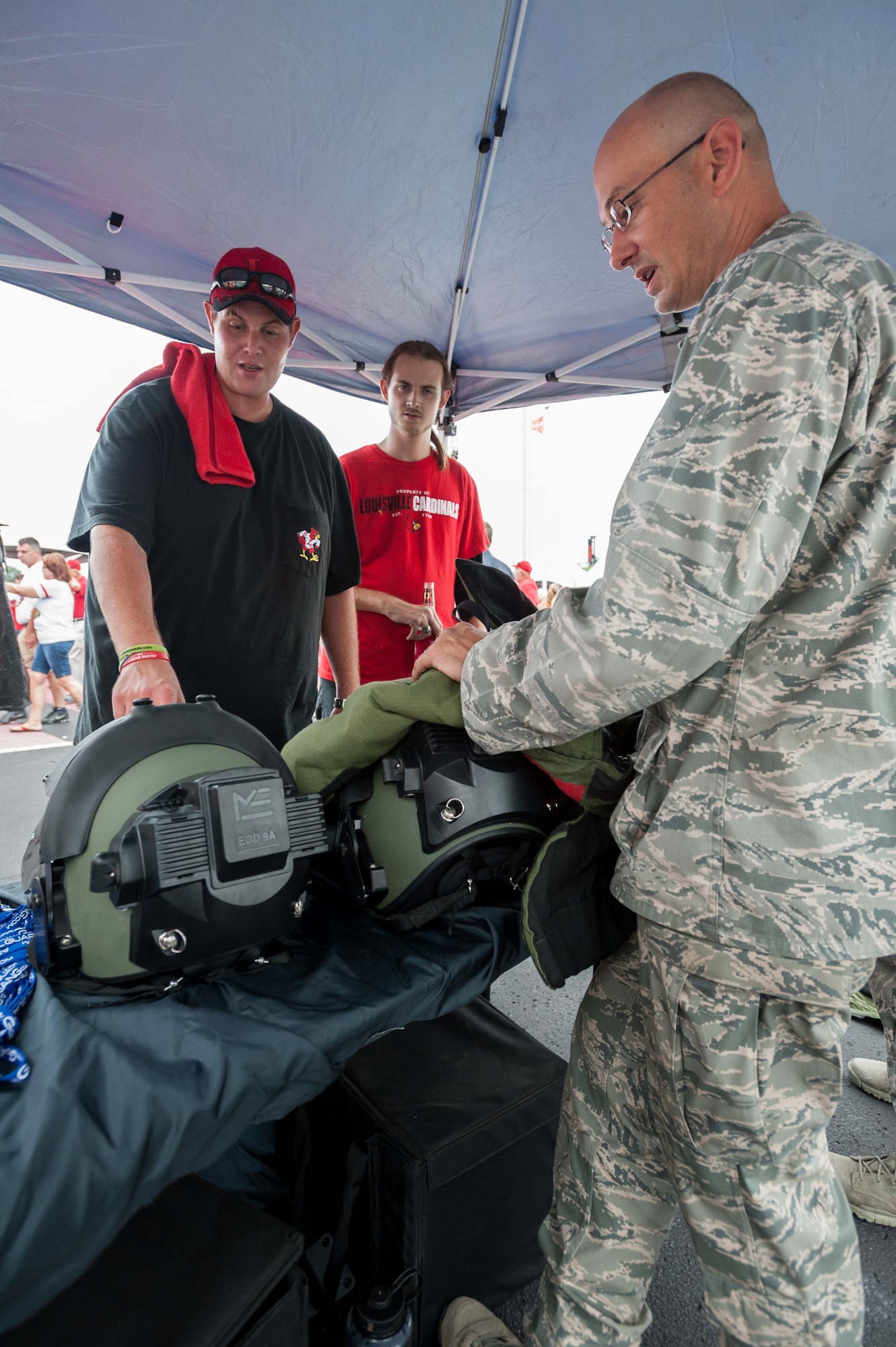 Air Force Maj. Keith Smith, commander of the Kentucky Air National Guard’s 123rd Explosive Ordnance Disposal Flight, displays EOD protective equipment to a football fan outside Papa John’s Cardinal Stadium in Louisville, Ky., prior to the University of Louisville – Murray State football game Sept. 6, 2014. The game, billed as Military Appreciation Day, began with a coin toss executed by Air Force Brig. Gen. Warren Hurst, the Kentucky National Guard's assistant adjutant general for Air and commander of the Kentucky Air National Guard. (U.S. Air National Guard photo by Maj. Dale Greer/Released)
