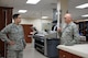 Tech. Sgt. Richy Krueger, Air Force Mortuary Affairs Operations deployer, and his home station commander, Maj. Jason Miller, 934th Sustainment Services commander, discuss operations in the uniform section of the Charles C. Carson Center for Mortuary Affairs, Dover Air Force Base, Del., during a unit morale visit Sept. 16, 2014. Krueger is deployed to the mortuary from the 934th Force Support Squadron, Minneapolis St. Paul Air Reserve Station, Minn. (U.S. Air Force photo/Staff Sgt. Lucas Morrow)