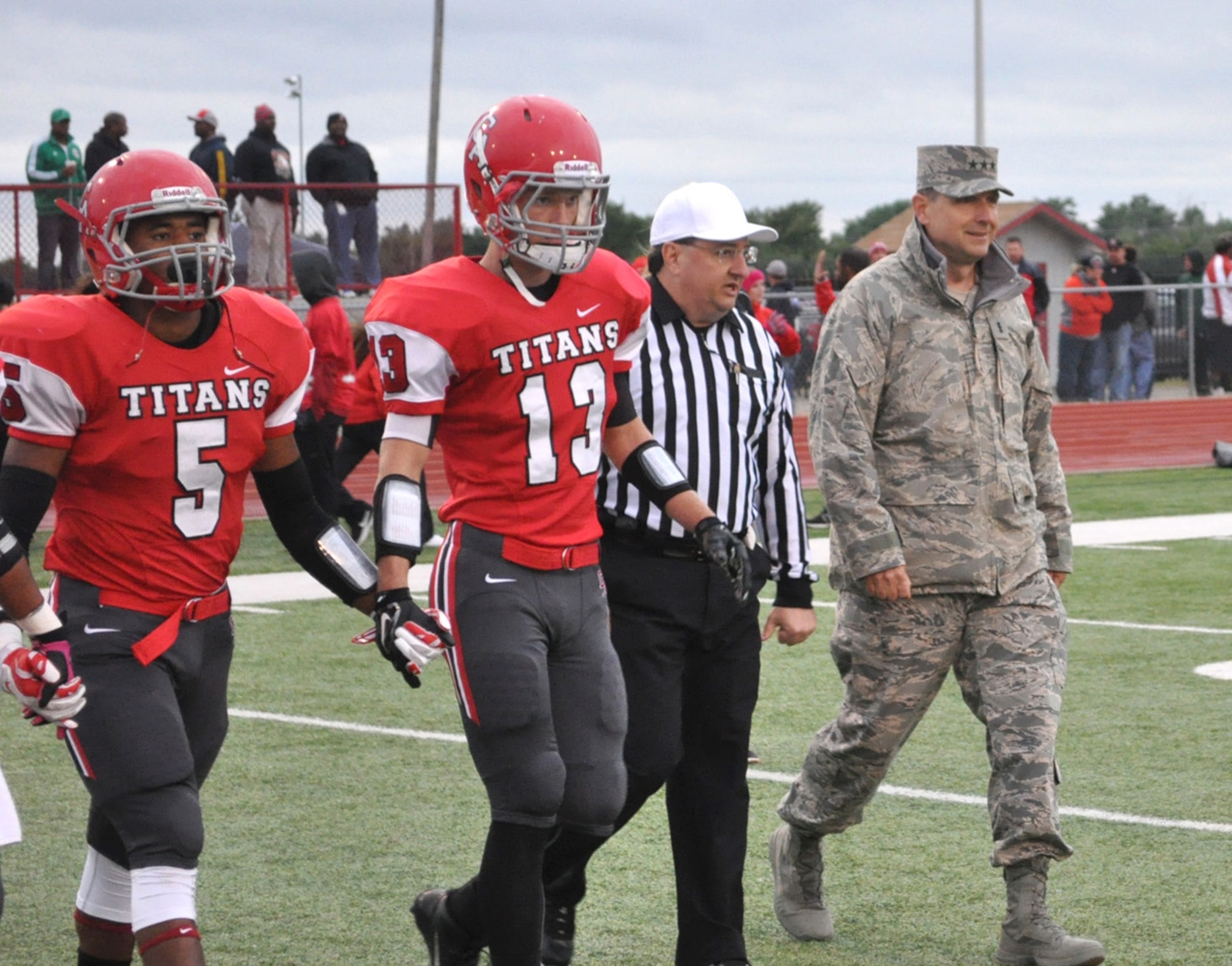 Air Force Sustainment Center Commander Lt. Gen. Bruce Litchfield approaches midfield for Friday night’s coin toss between the Midwest City Bombers and the Carl Albert Titans. The general performed the ceremonial coin toss to start the game. Midwest City won 18-0. (Air Force photo by Michael S. Della Vecchio)