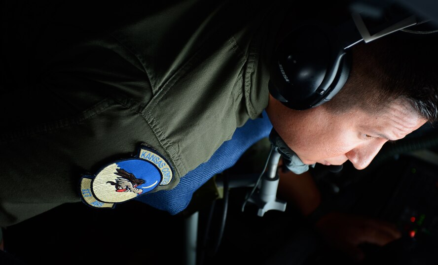 U.S. Air Force Tech. Sgt. Ben Tressler, an in-flight refueling specialist from the 117th Air Refueling Squadron based out of Topeka, Kan., operates the boom of a U.S. Air Force KC-135 Stratotanker during an aerial refueling mission at Spangdahlem Air Base, Sept. 18, 2014.Tressler hails from Yates Center, Kan., and has been to 29 countries in his career. (U.S. Air Force photo by Airman 1st Class Luke J. Kitterman/Released)