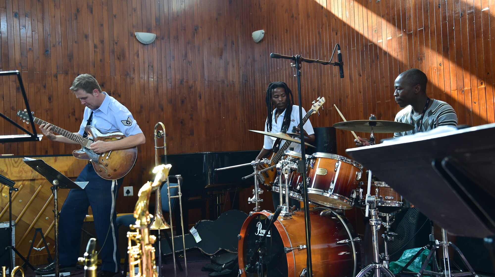 U.S. Air Forces in Europe’s Wings of Dixie jazz band guitarist Staff Sgt. Joseph Gacioch jams with music students at the Music Academy of Gauteng in Benoni, South Africa, after a free, live concert Sept, 18, 2014. The jazz band played for nearly two hours straight after a music workshop designed to enhance the student’s’ knowledge on certain instruments. (Courtesy photo/Danté Khwandi)