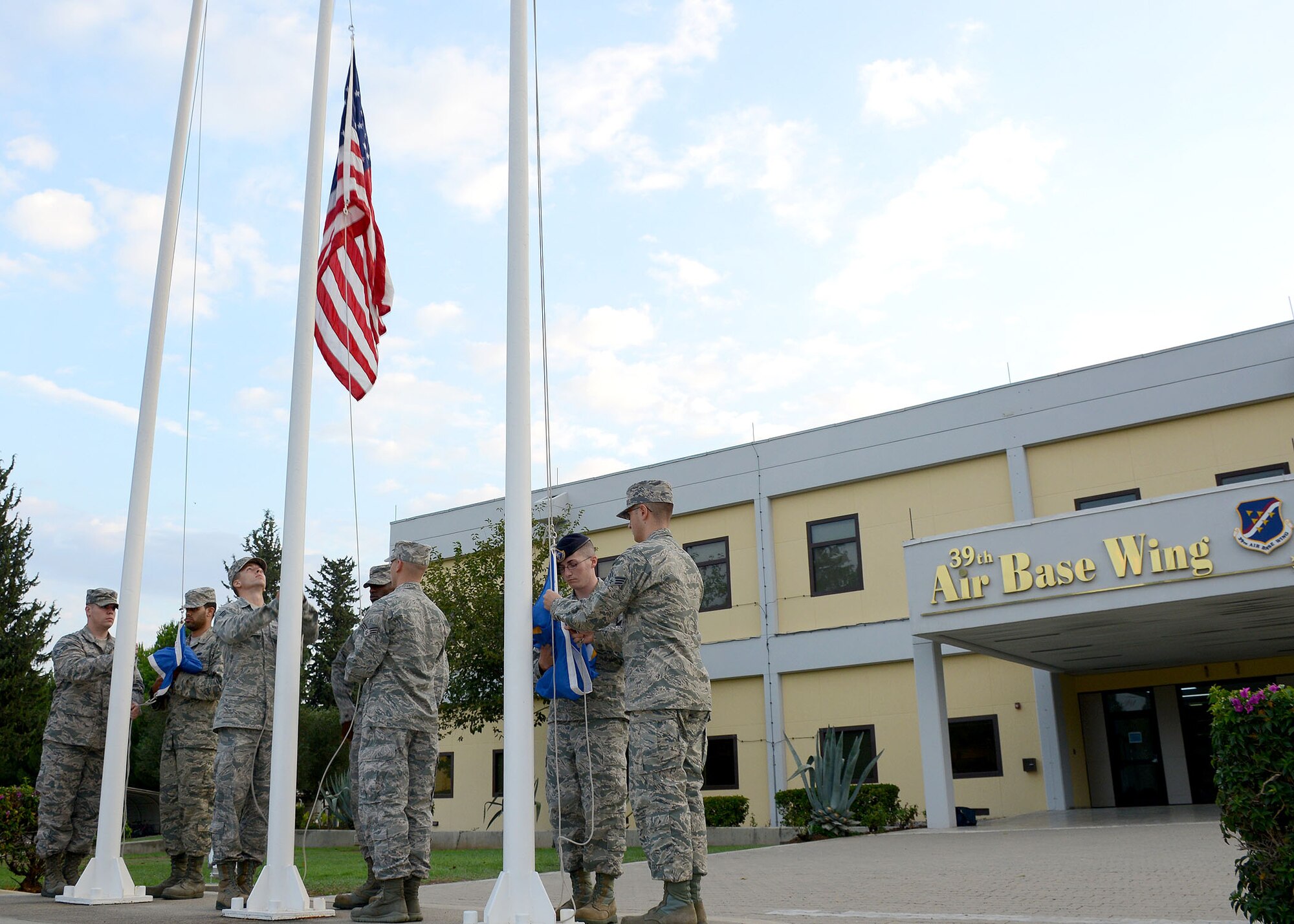 Students from Airman Leadership School class 14-6, raise the American flag during a prisoner of war, missing in action remembrance ceremony Sept. 19, 2014, Incirlik Air Base, Turkey. Members of the 39th Air Base Wing gathered to pay their respects to Americans who are still missing in action or prisoners of our enemy. (U.S. Air Force photo by Staff Sgt. Veronica Pierce/Released) 