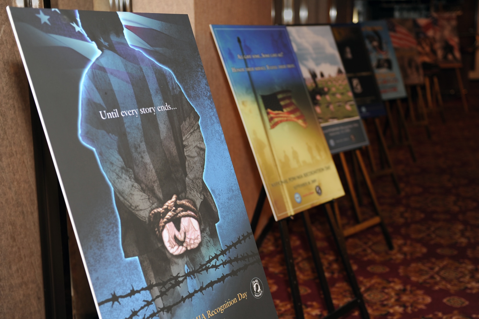 Posters for past National Prisoner of War and Missing in Action Recognition Days line a wall at the Rocker NCO club on Kadena Air Base, Japan, Sept. 19, 2014. National POW/MIA Day serves as a reminder of the service members who endured imprisonment by opposing forces as well as those who never returned from battle. (U.S. Air Force photo by Airman 1st Class Zade C. Vadnais/Released)