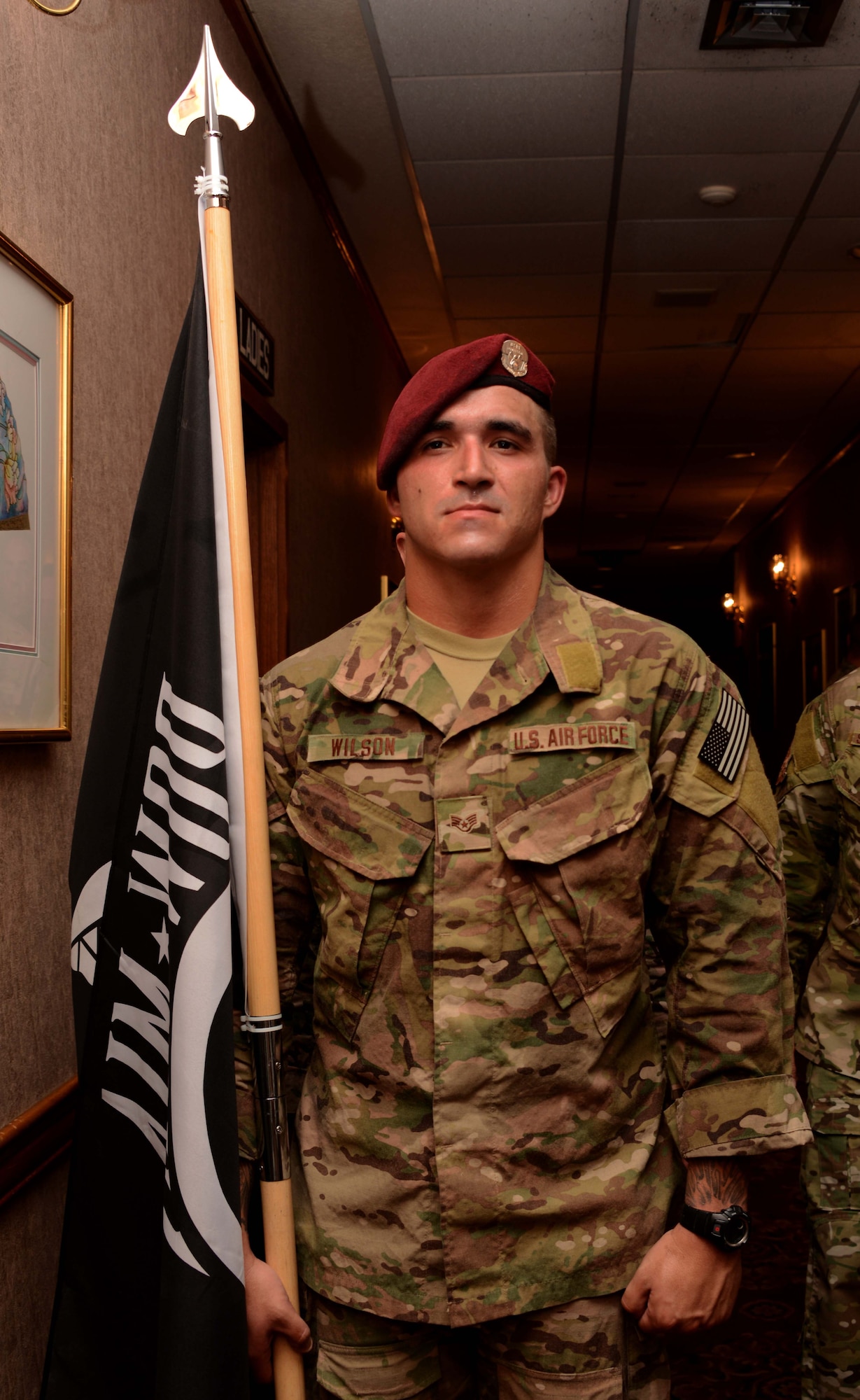 Staff Sgt. Christopher Wilson, a pararescueman from the 320th Special Tactics Squadron, prepares to present the POW/MIA flag during the POW/MIA recognition breakfast held Sept. 19, 2014 at the NCO Rocker Club.   The breakfast hosted by the Air Force Sergeants Association Chapter 1553 paid tribute to former prisoners of war and those missing in action.   National POW/MIA Recognition Day is held annually on the third Thursday in September.  (U.S. Air Force photo by Tech. Sgt. Kristine Dreyer)