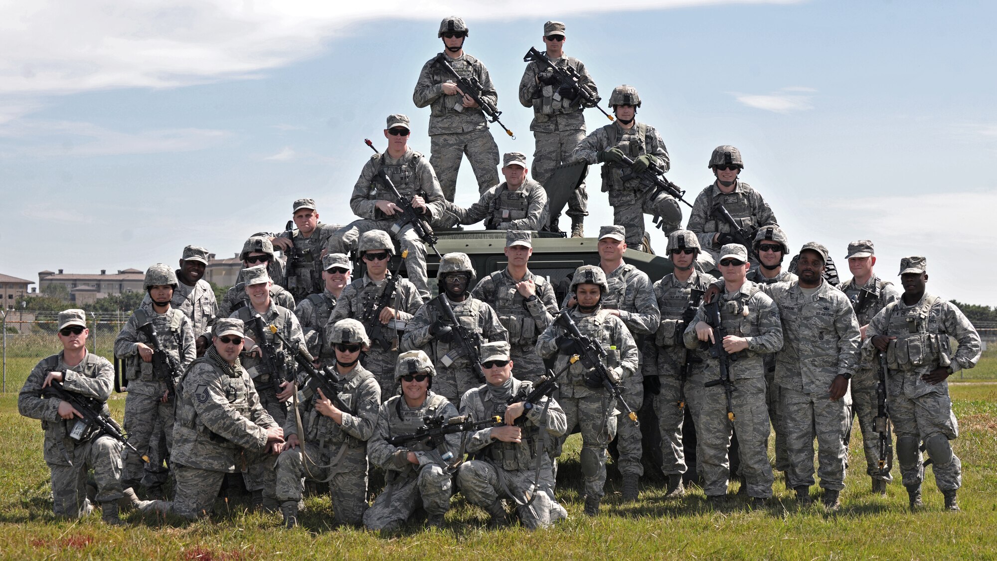 8th Security Forces Squadron members pose in front of a Humvee after completing combat readiness training Sept. 16 at Kunsan Air Base, Republic of Korea. More than 250 security forces Airmen trained alongside Republic of Korea Air Force members Sept. 15 to 17 to ensure a seamless transition from armistice to contingency operations during both exercises and real-world situations. (U.S. Air Force photo/Senior Airman Katrina Heikkinen)