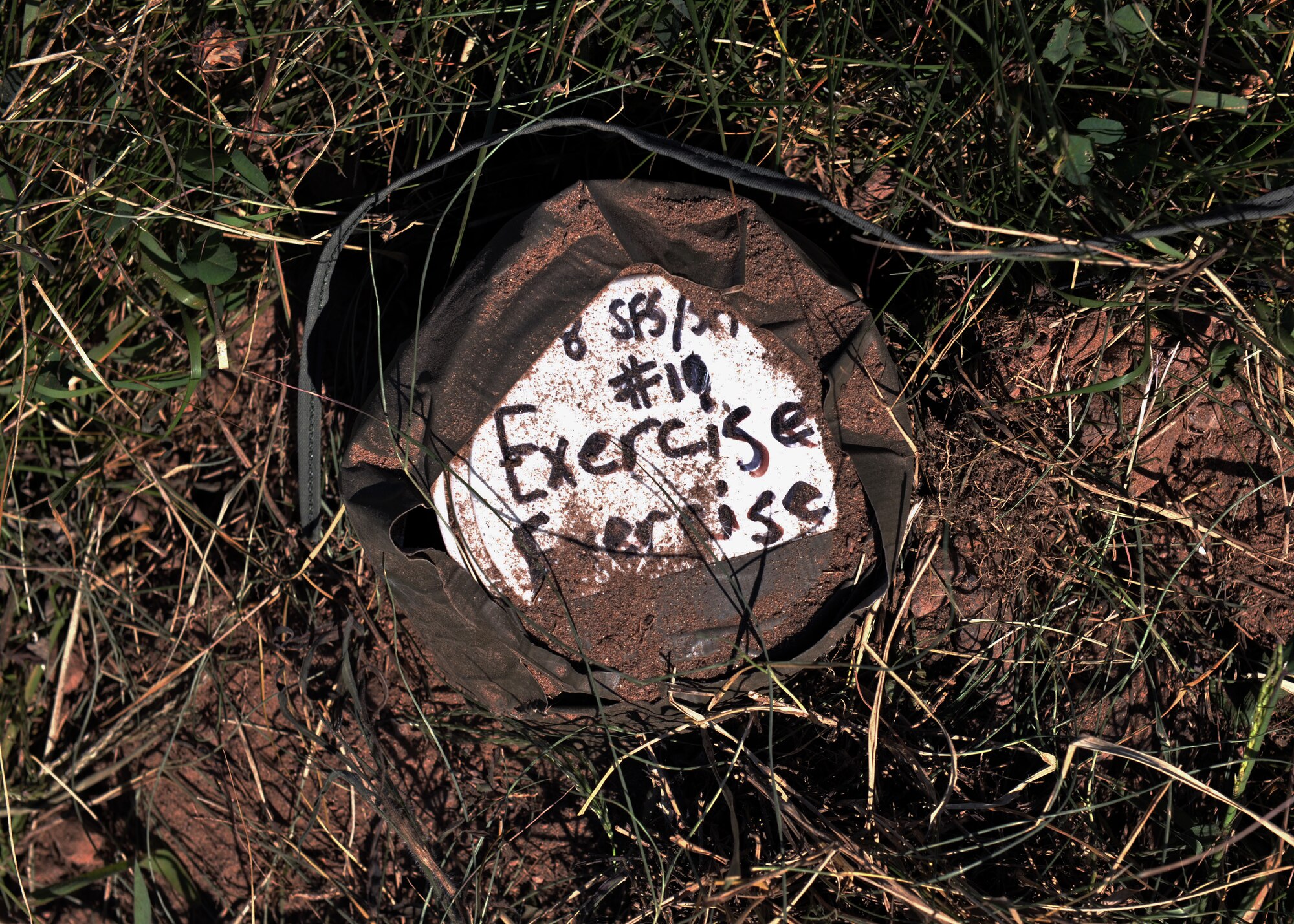 A simulated improvised explosive device is positioned on the path of a convoy during 8th Security Forces Squadron combat readiness training at Kunsan Air Base, Republic of Korea. More than 250 security forces Airmen trained alongside ROK Air Force and special operations forces members Sept. 15 to 17 to ensure a seamless transition from armistice to contingency operations during both exercises and real-world threats. (U.S. Air Force photo/Senior Airman Katrina Heikkinen)
